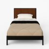 Clara Bed with brown headboard and beige bedding.